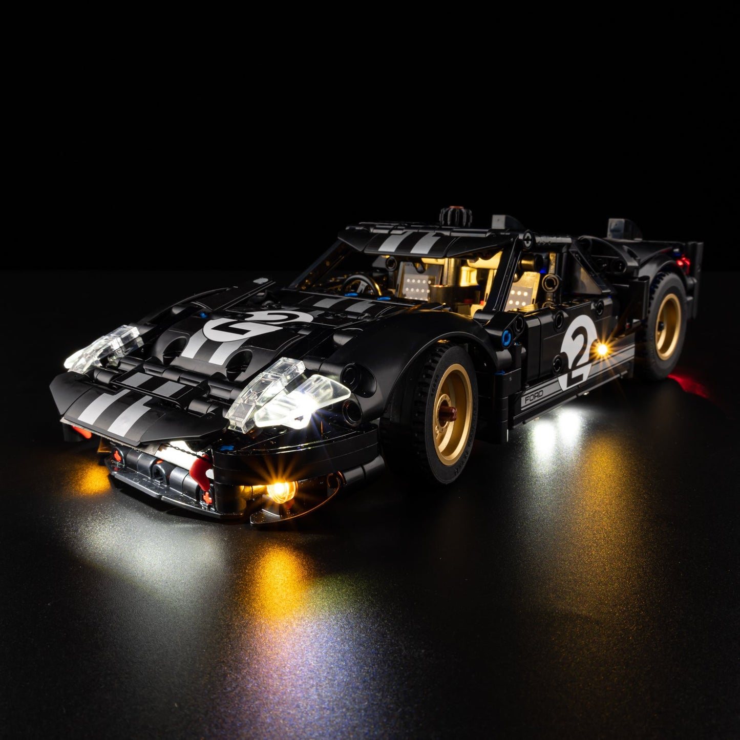 Light Kit for LEGO 1966 Ford GT40 MKII Race Car 42223 - rear three-quarter view with blue underglow and gold wheels